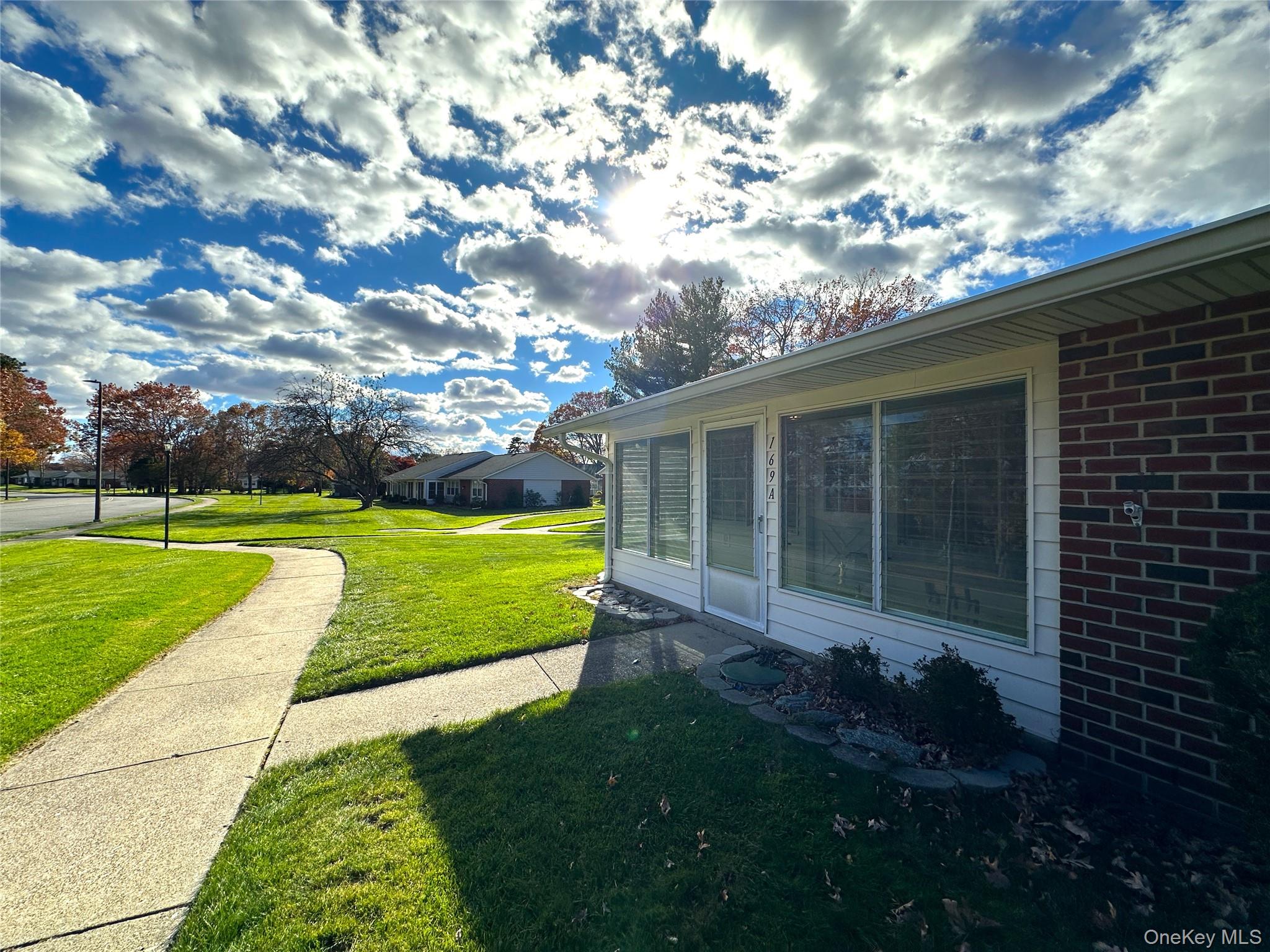 169 Ventry Court, Unit A Ridge, NY 11961 - Photo 13 of 17 a view of a house with a back yard