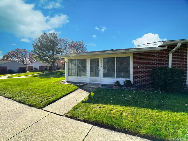 a view of a house with yard and a garden