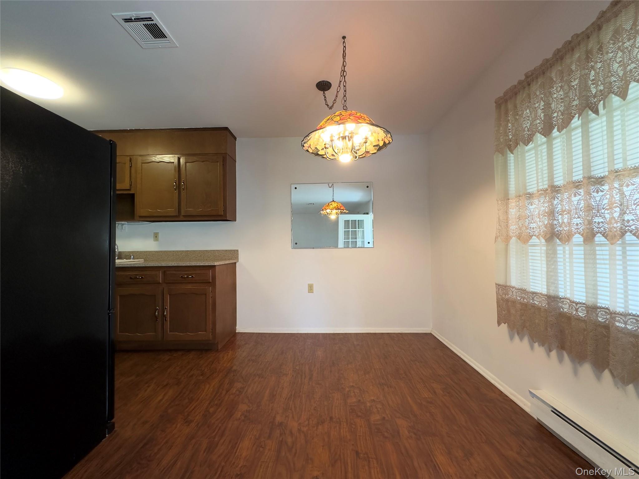 169 Ventry Court, Unit A Ridge, NY 11961 - Photo 7 of 17 a view of a kitchen with a sink and dishwasher wooden floor