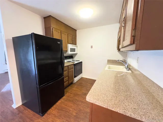 a kitchen with stainless steel appliances granite countertop a refrigerator and a sink