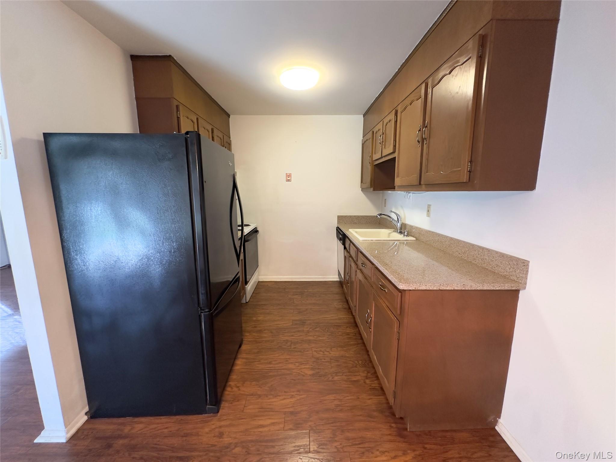 169 Ventry Court, Unit A Ridge, NY 11961 - Photo 9 of 17 a hallway with sink washer and dryer
