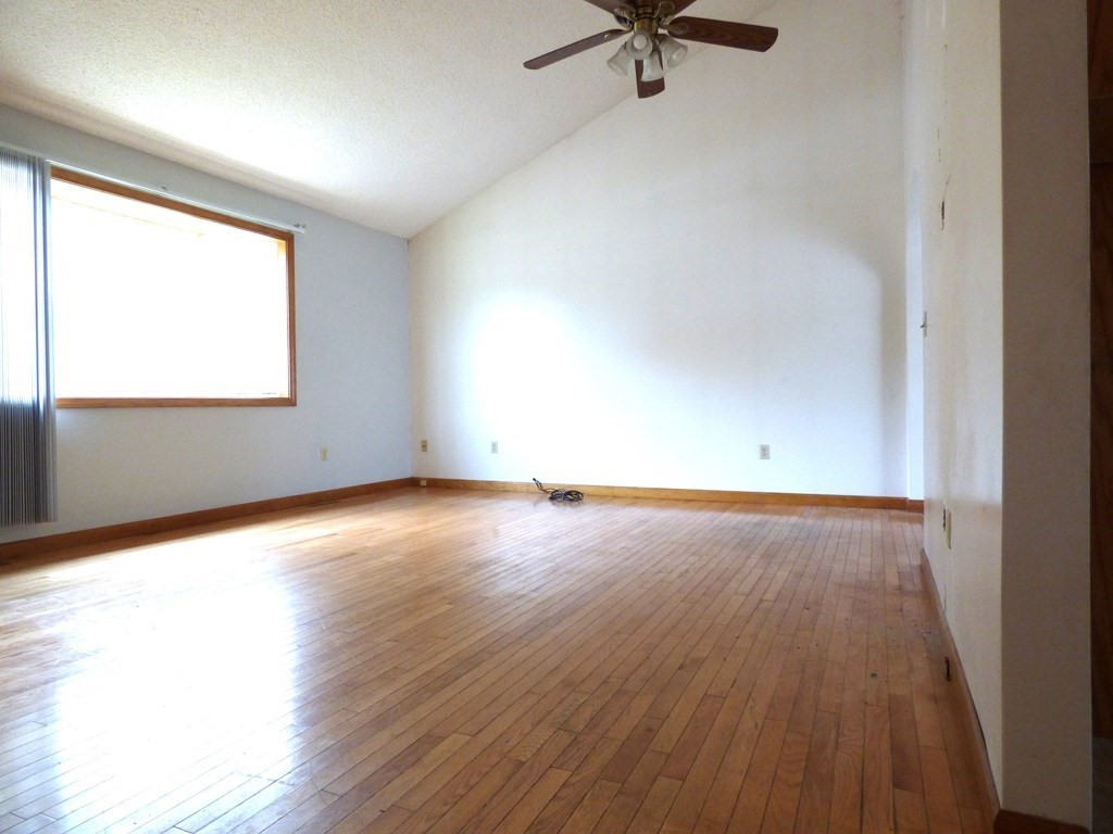 6 Devonshire Road Springfield, MA 01109 - Photo 3 of 23 an empty room with wooden floor fan and windows