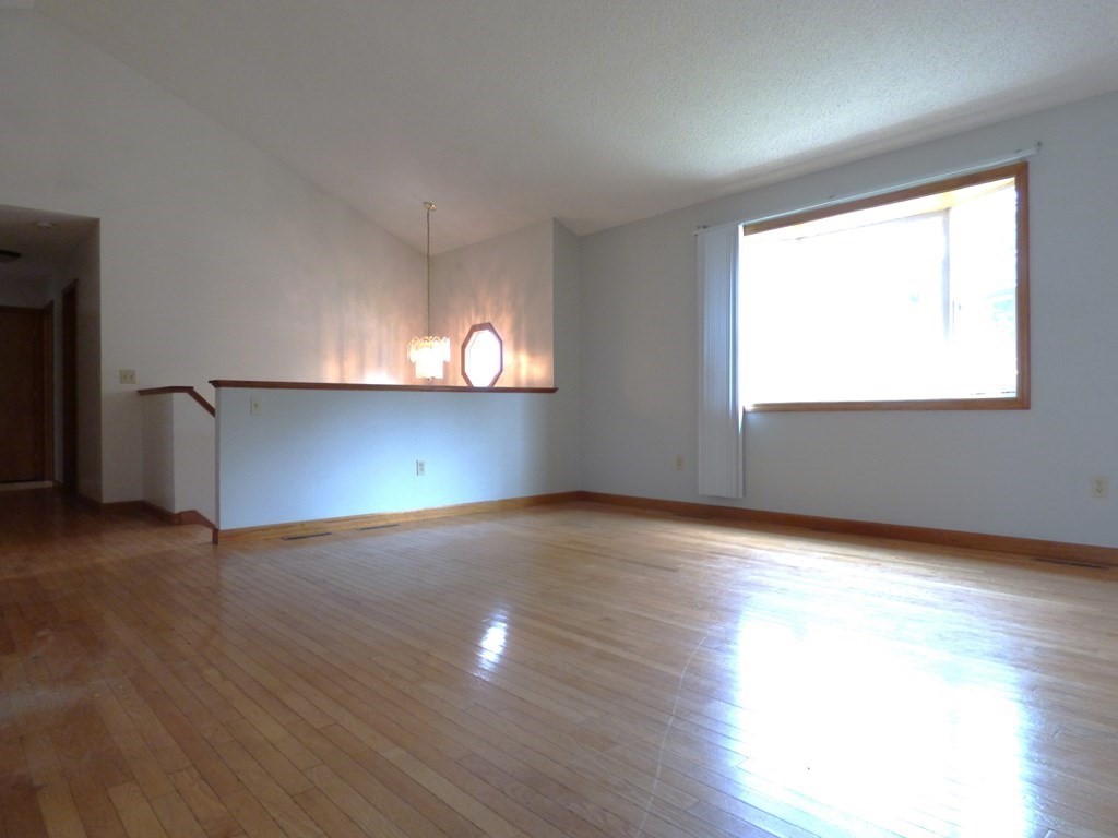 6 Devonshire Road Springfield, MA 01109 - Photo 4 of 23 an empty room with wooden floor and windows