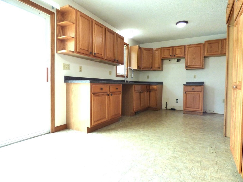 6 Devonshire Road Springfield, MA 01109 - Photo 6 of 23 a kitchen with stainless steel appliances granite countertop a sink and cabinets