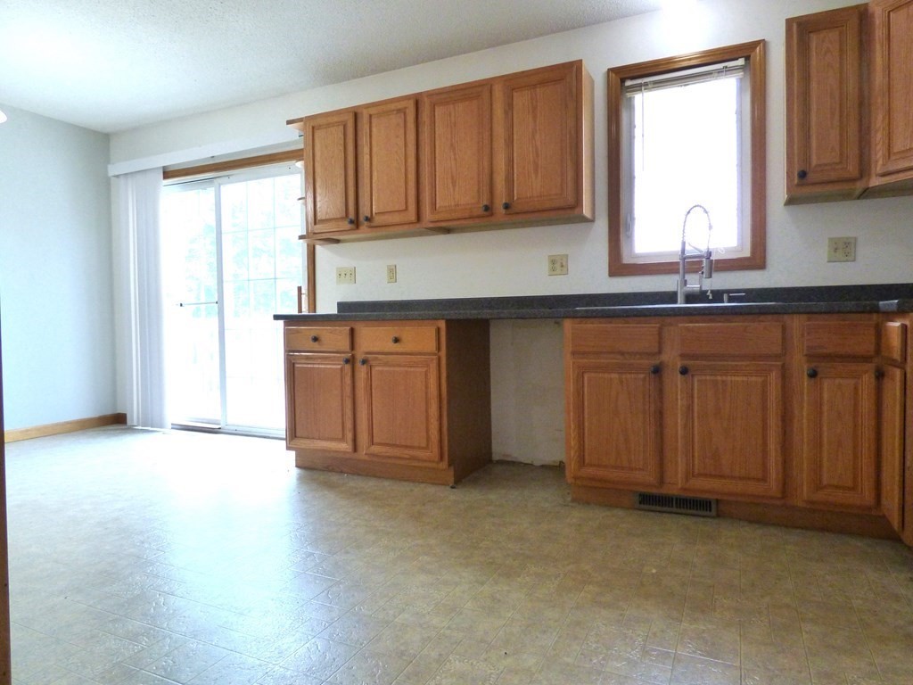6 Devonshire Road Springfield, MA 01109 - Photo 7 of 23 a kitchen with stainless steel appliances granite countertop wooden cabinets a sink and a window
