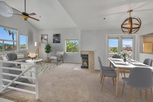 a living room with furniture a chandelier and a window