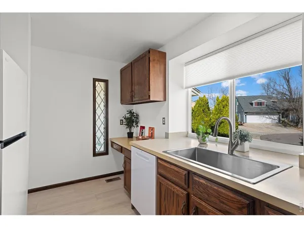 a kitchen with stainless steel appliances a sink a refrigerator and a counter space