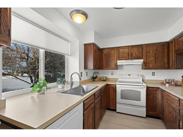 a kitchen that has a sink and a stove in it