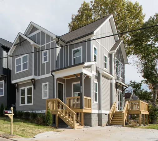 a view of a white house with large windows