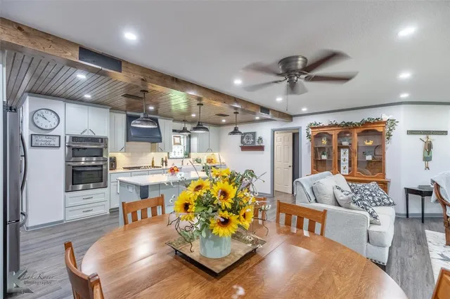 a living room with lots of furniture and kitchen view