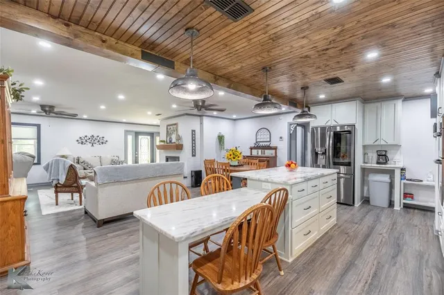 a living room with lots of furniture and kitchen view