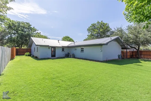 a view of a backyard with a garden and trees