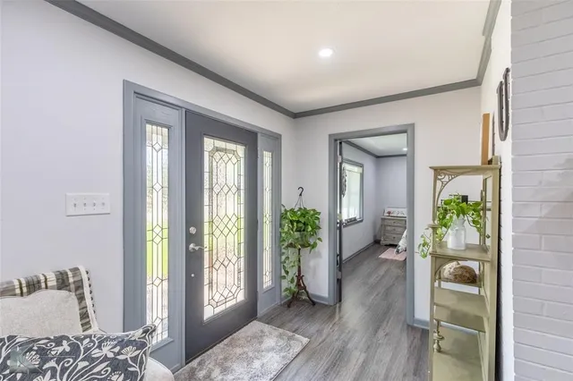 a view of an entryway with wooden floor