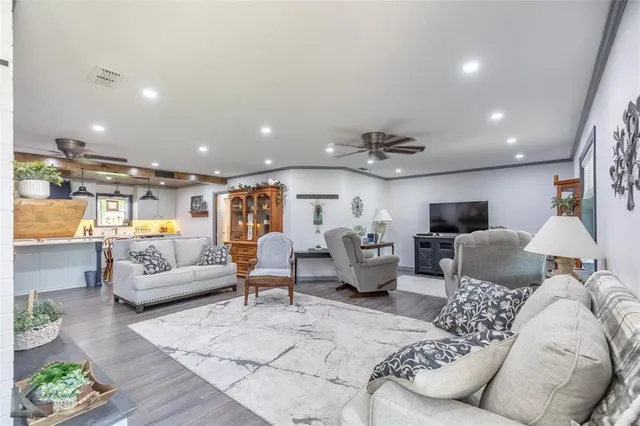 a living room with furniture and a chandelier