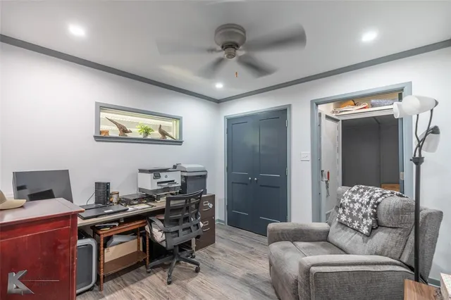 a livingroom with workspace couch and a window