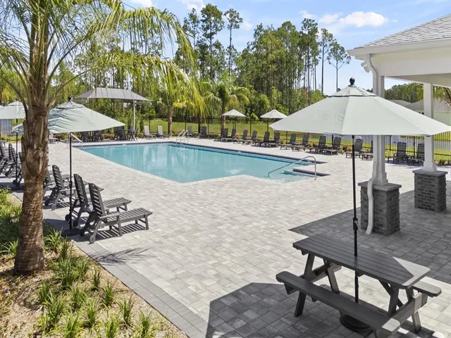a view of a terrace with chairs and potted plants