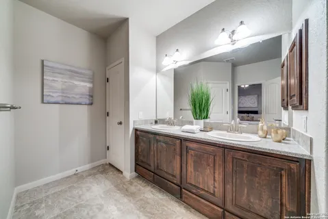a spacious bathroom with a double vanity sink and a mirror