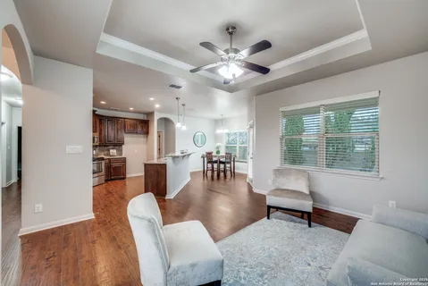a dining room with wooden floor and a chandelier