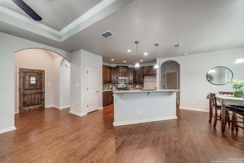 a view of kitchen with cabinets and wooden floor