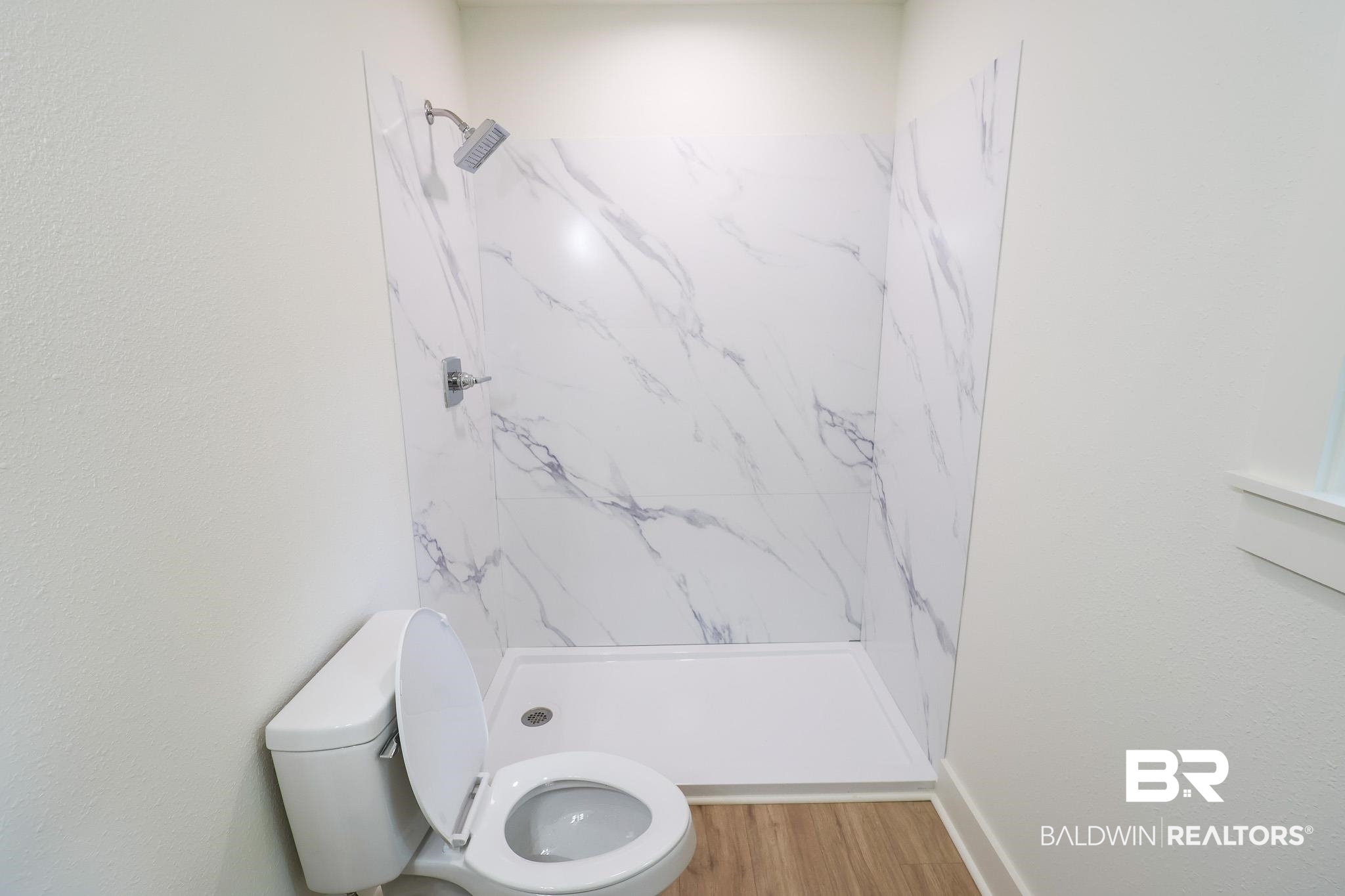 12190 Pecan Grove Street Magnolia Springs, AL 36555 - Photo 29 of 45 Bathroom with a tile shower, hardwood / wood-style flooring, and toilet