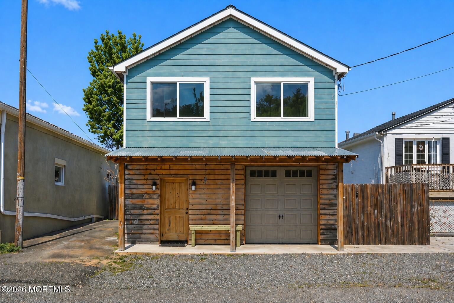 a view of a house with wooden fence