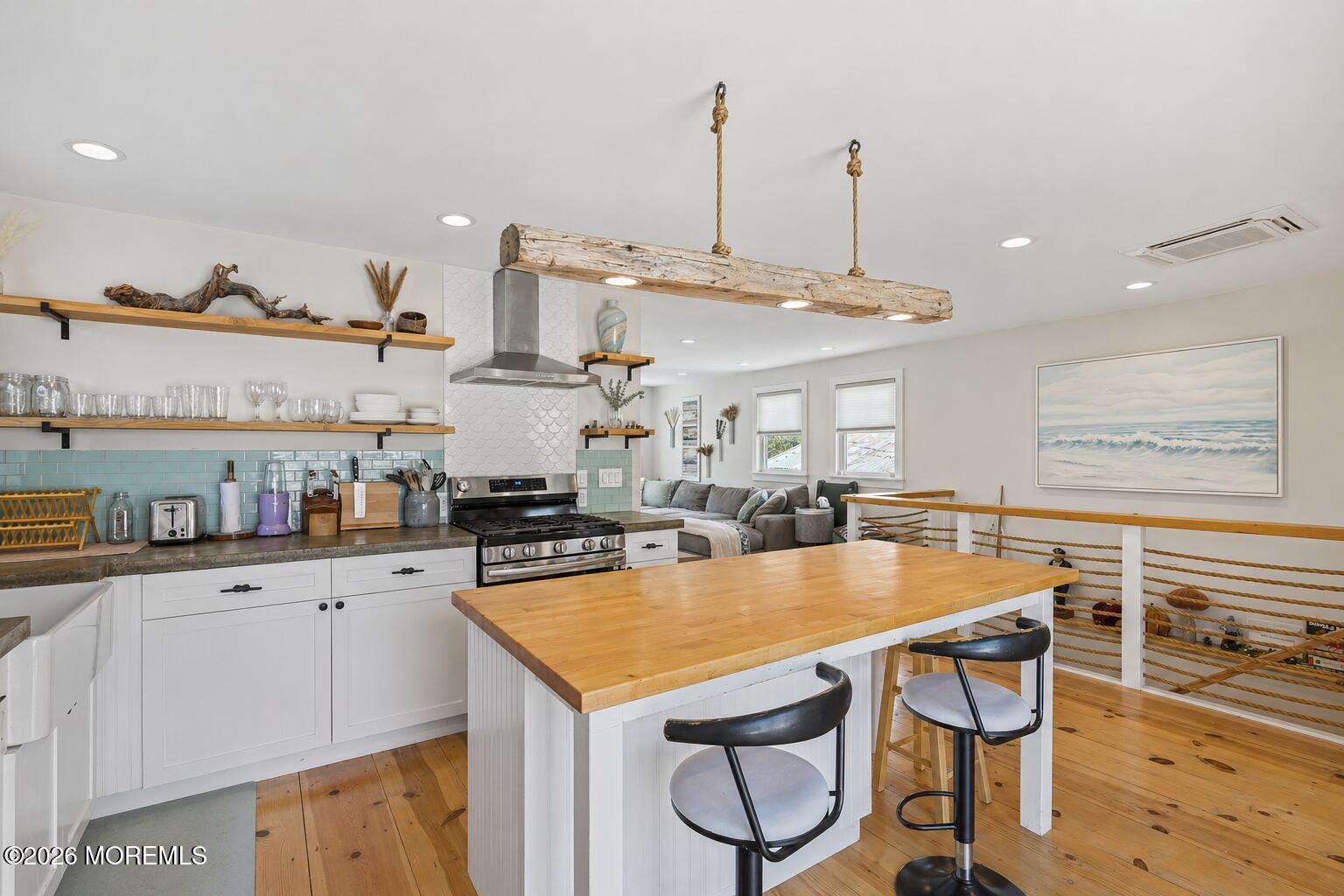 30 2nd Street Highlands, NJ 07732 - Photo 7 of 29 a kitchen with stainless steel appliances granite countertop a sink a stove and chairs