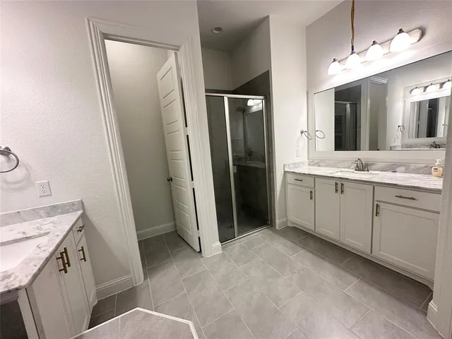 a bathroom with a sink a toilet a mirror a vanity and shower