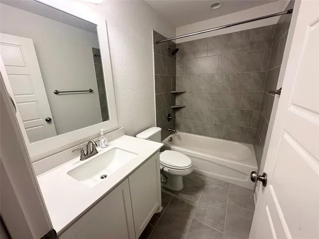 a bathroom with a sink mirror vanity and toilet
