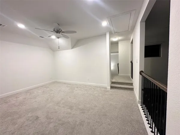 an empty room with a empty space and a ceiling fan