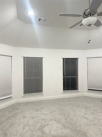 a view of an empty room with windows