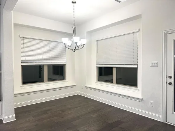 a view of an empty room with a fireplace and a window