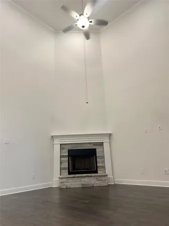 a view of a livingroom with a fireplace and a ceiling fan