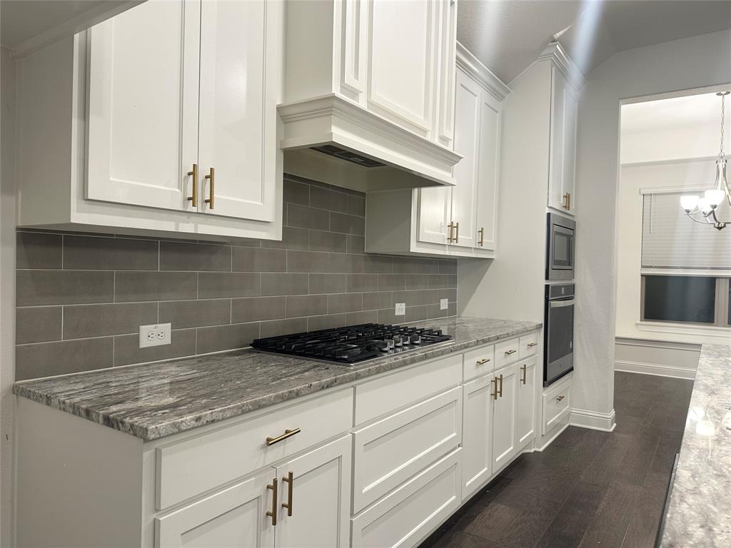 2604 Henley Way Venus, TX 76084 - Photo 9 of 14 a kitchen with stainless steel appliances granite countertop a sink and a stove