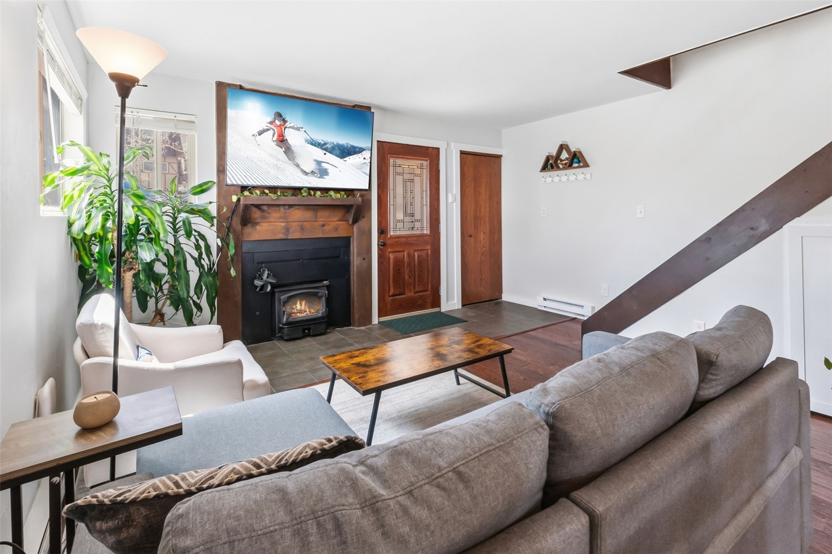 6920 Ryan Gulch Road, Unit 6920 Silverthorne, CO 80498 - Photo 4 of 48 a living room with furniture a fireplace and a potted plant