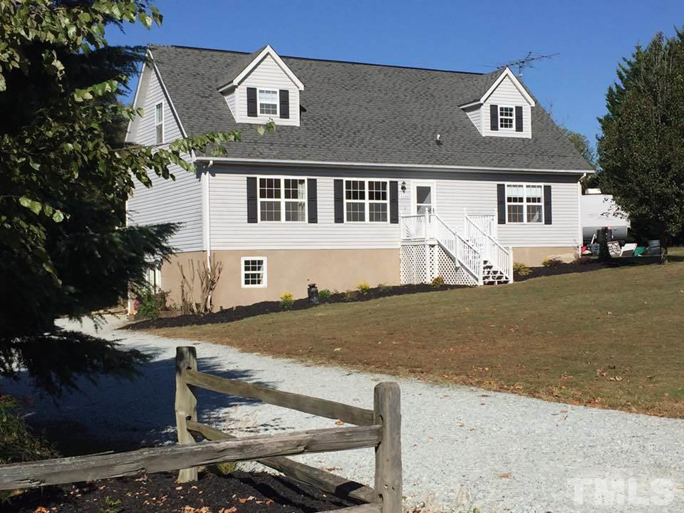 1150 Robertson Road Roxboro, NC 27574 - Photo 1 of 21 a front view of a house with a yard