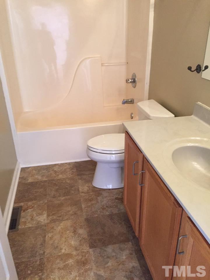 1150 Robertson Road Roxboro, NC 27574 - Photo 12 of 21 a bathroom with a sink a toilet and a mirror