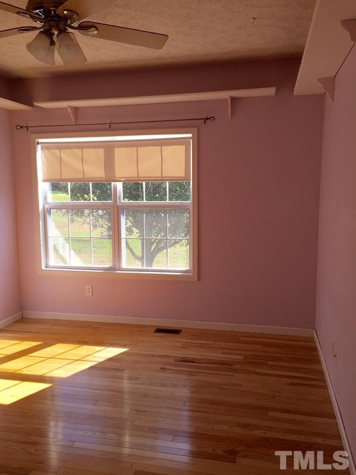 1150 Robertson Road Roxboro, NC 27574 - Photo 14 of 21 an empty room with wooden floor and windows