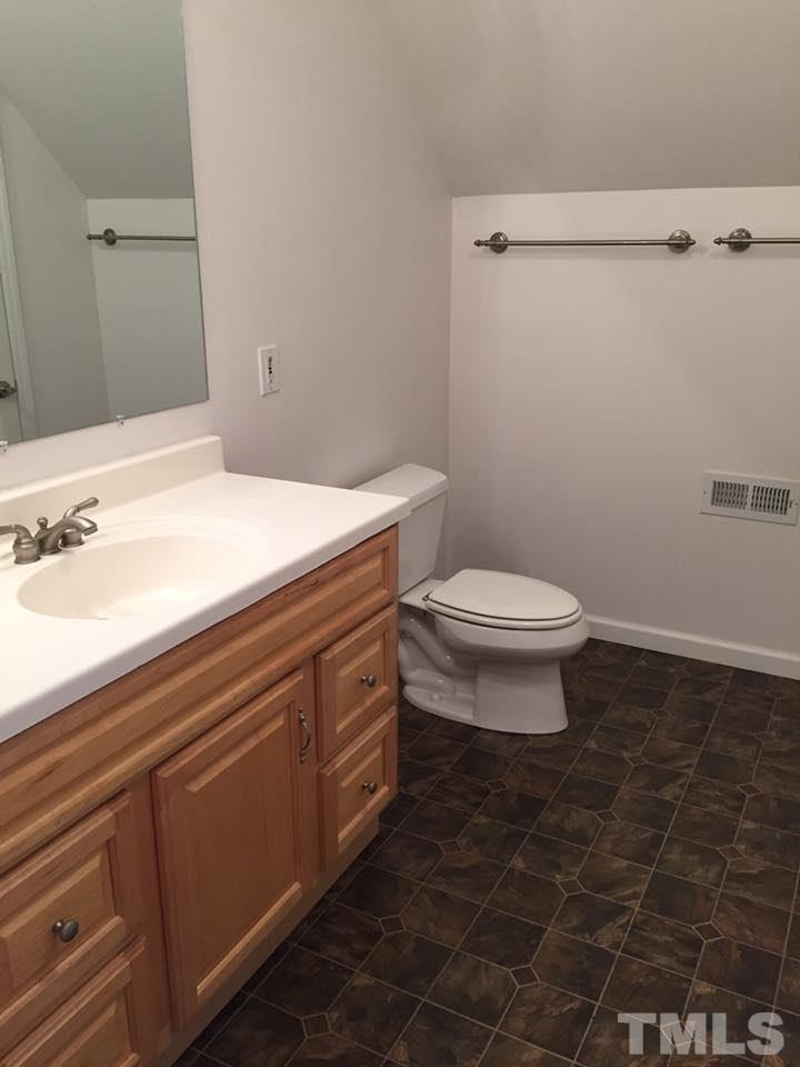 1150 Robertson Road Roxboro, NC 27574 - Photo 16 of 21 a bathroom with a sink a toilet and a mirror