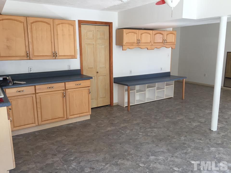 1150 Robertson Road Roxboro, NC 27574 - Photo 19 of 21 a kitchen with granite countertop white cabinets and sink
