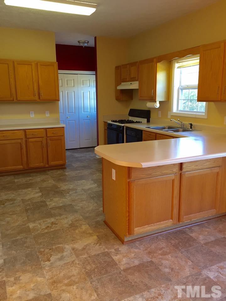 1150 Robertson Road Roxboro, NC 27574 - Photo 3 of 21 a kitchen with stainless steel appliances a stove a microwave a sink and a refrigerator