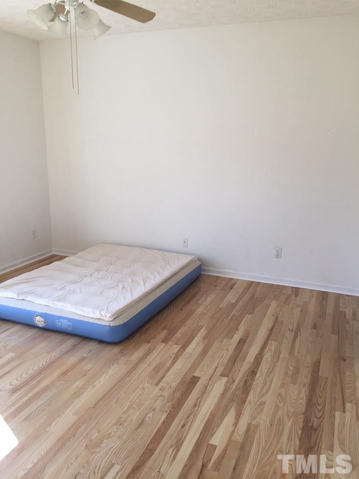 1150 Robertson Road Roxboro, NC 27574 - Photo 10 of 21 a view of a room with wooden floor and fan