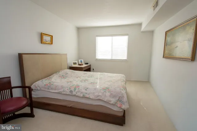 a bedroom with a bed and chair