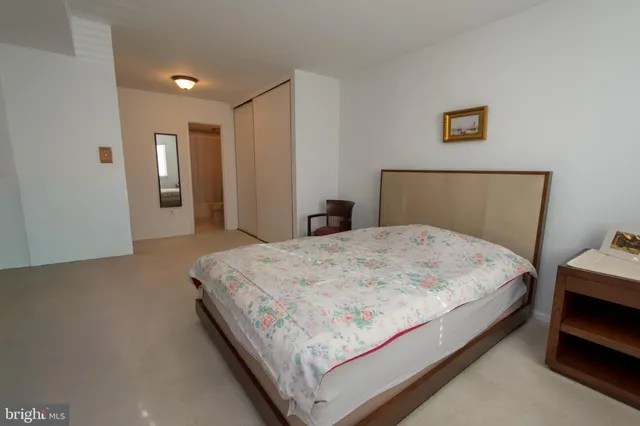 a large bed sitting in a bedroom and a table