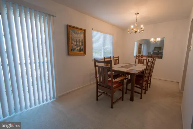 a dining room with furniture and chandelier kitchen view