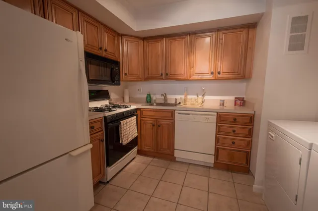 a kitchen with a stove sink and cabinets