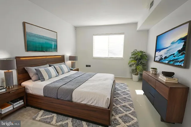 a bedroom with a bed and a couch