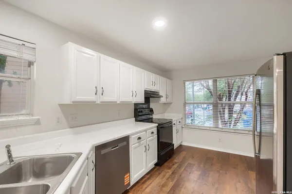 a kitchen with a sink stove and cabinets