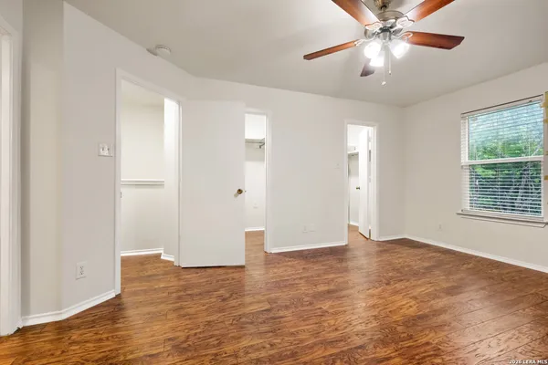 a view of an empty room with wooden floor