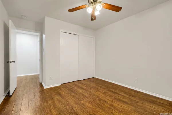a view of a room with wooden floor