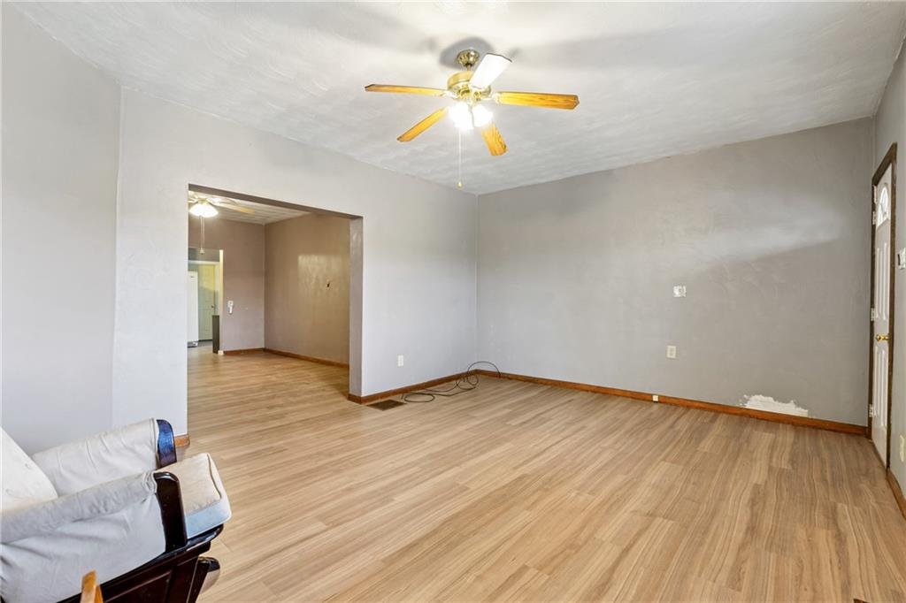 723 Freeport Road Creighton, PA 15030 - Photo 11 of 27 an empty room with wooden floor and a ceiling fan